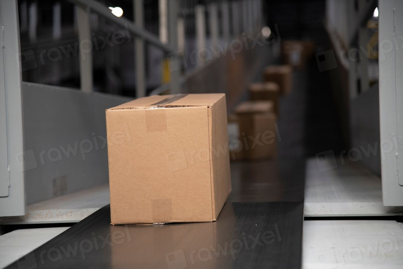 Cardboard package moving down a shipping conveyor