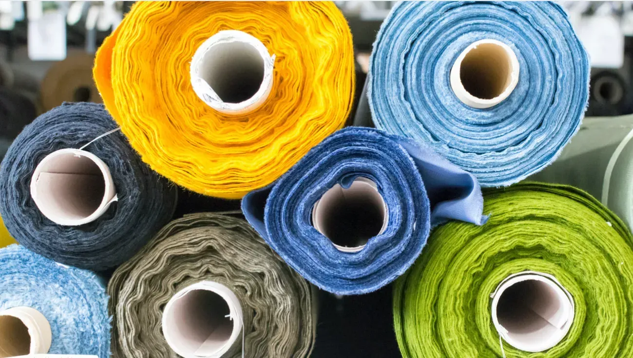 Textile paper tubes carrying colorful fabric and yarn rolls